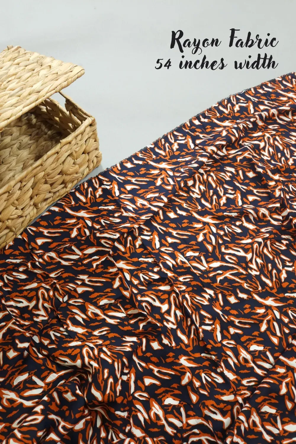 Dark navy blue base with leaf printed white and orange rayon fabric, 54 inches width
