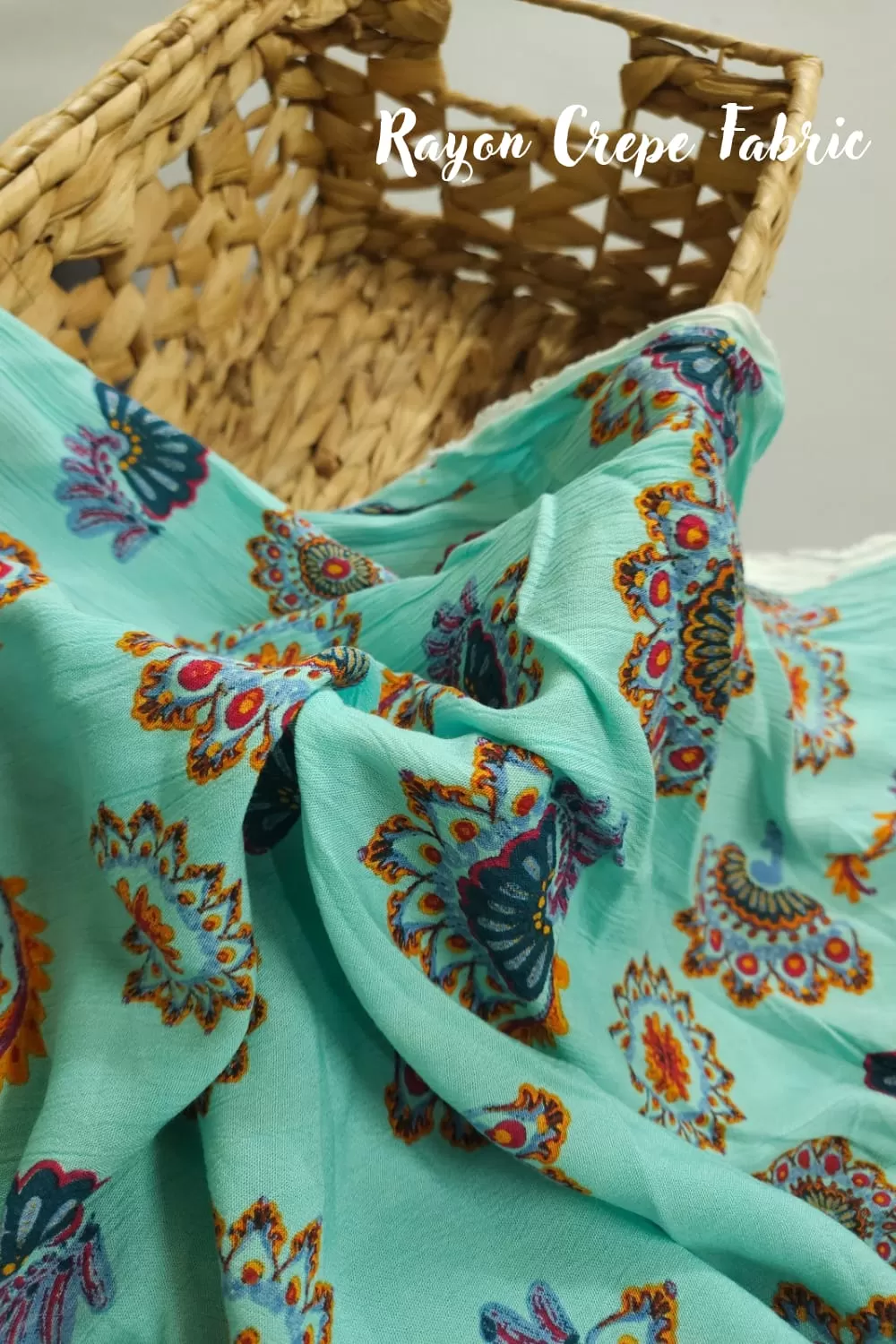 Sea green base with rangoli printed rayon crepe fabric, 42 inches width